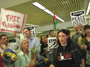 Katrina Plotz (right) speaks at a press conference Monday at the Minneapolis-St. Paul International Airport’s Lindbergh Terminal. She had just arrived in the Twin Cities, along with Sarah Martin (left), after being denied entry into Israel. (Photo: Mordecai Specktor)