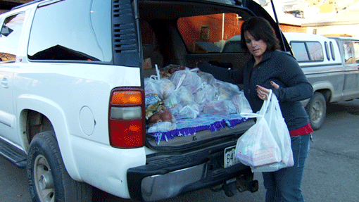 In a scene from the documentary "A Place at the Table," a 5th grade teacher in Collbran, Colo., loads groceries from a food shelf. (Photo courtesy of Magnolia Pictures)