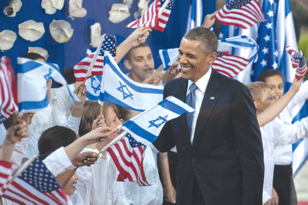 President Obama greeted by children waving Israeli and American flags at a welcoming ceremony at Shimon Peres’ residence in Jerusalem on March 20. (Photo: Uri Lenz / FLASH90 / JTA)