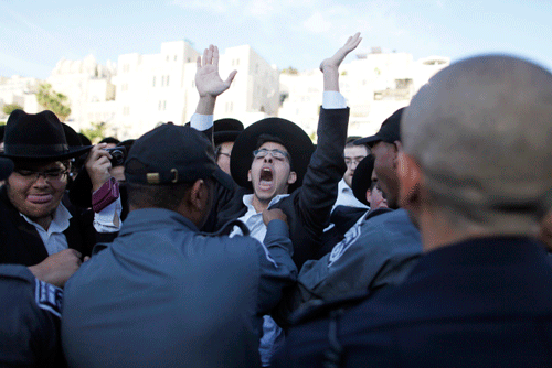Israeli riot police scuffle with haredi Orthodox Jews at the Western Wall plaza in a bid to keep them away from Women of the Wall's monthly prayer service at the holy site in Jerusalem on May 10. (Photo: Flash90)