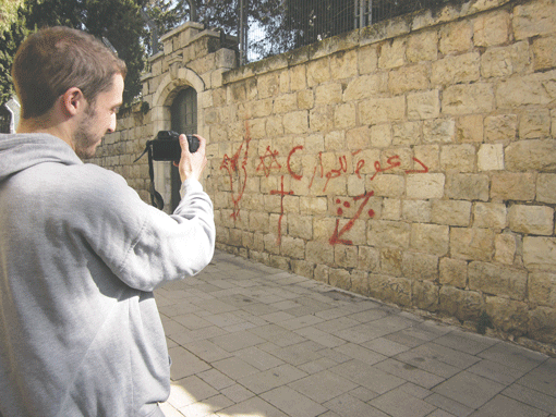Adam Heffez photographs graffiti promoting coexistence in Jerusalem. (Photo: Courtesy of Adam Heffez)