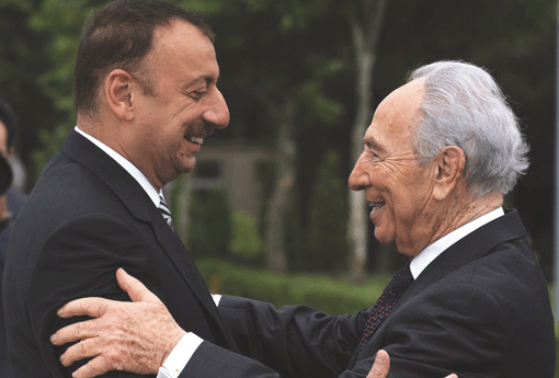 Azeri President Ilham Aliyev (left) greets Israeli President Shimon Peres at the presidential palace in Baku on June 28, 2009. (Photo: Amos Ben Gershom/GPO via Getty Images)