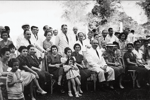 Alex Frieder, seated, surrounded by Jewish refugees that he and his brothers helped escape from Nazi Germany and Austria to the Philippines. (JTA/ Courtesy of 3 Roads Communications.)