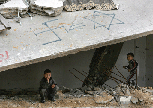 Palestinian children play in a damaged building with a swastika and the Star of David painted on it in a Gaza refugee camp in 2005. The ADL’s survey found that 93 percent of respondents in the West Bank and Gaza have anti-Semitic views. (Photo: Abid Katib / Getty Images)