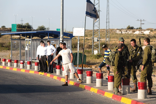 Israeli soldiers guarding near where Jewish settlers hitchhike at the Gush Etzion junction in the West Bank on June 16. (Photo: Flash 90)