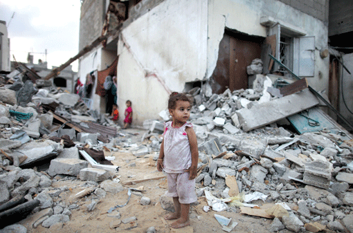 A Palestinian child amid the rubble of homes destroyed by Israeli airstrikes in the northern Gaza Strip on Monday. (Photo: Emad Nasser / Flash90)