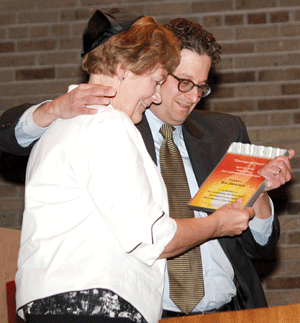 Steve Hunegs, director of the Jewish Community Relations Council of Minnesota and the Dakotas (JCRC), presents the Courage to Teach Award to Sue Devereux, of Mesabi Range College. (Photo: Ethan Roberts)