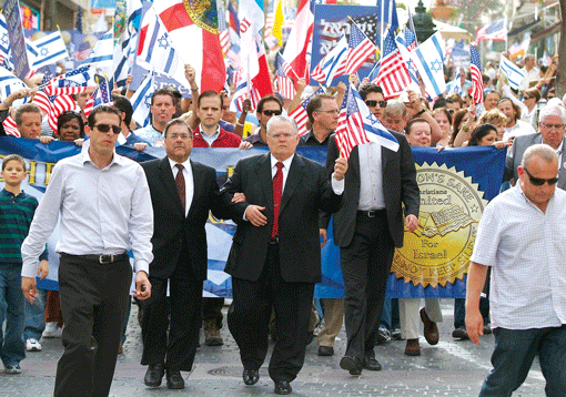 A Christians United for Israel (CUFI) solidarity march in Jerusalem in 2010. In center in front of the banner, holding American and Israeli flags, is CUFI founder Pastor John Hagee. (Photo: CUFI)