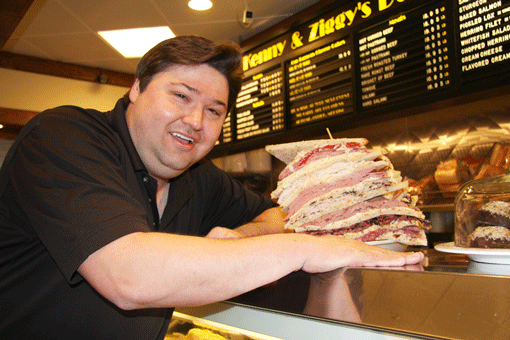 Ziggy Gruber, at Kenny and Ziggy’s in Houston, Texas, displays the $55 Zellagabetsky, an eight-decker sandwich on rye with corned beef, pastrami, turkey, roast beef, salami, tongue and swiss cheese with cole slaw and Russian dressing. Finish the Zellagabetsky by yourself in one sitting, and you get a free slice of cheesecake, which is also quite large. (Photo: Paula Murphy)