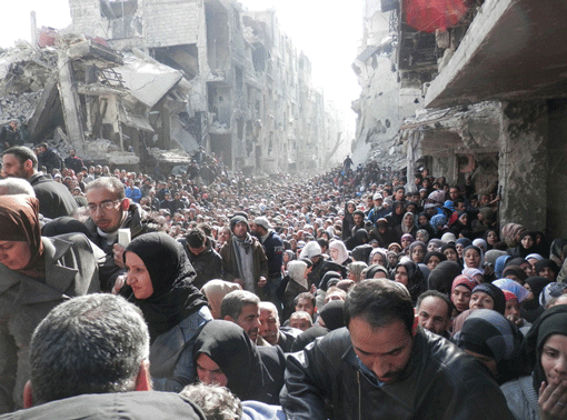 In January 2014, when UNRWA (United Nations Relief and Works Agency for Palestine Refugees) was able to complete its first humanitarian distribution in Yarmouk, after almost six months of siege, it was met by thousands of desperate residents on the refugee camp’s destroyed main street. (Photo: Courtesy of UNWRA)