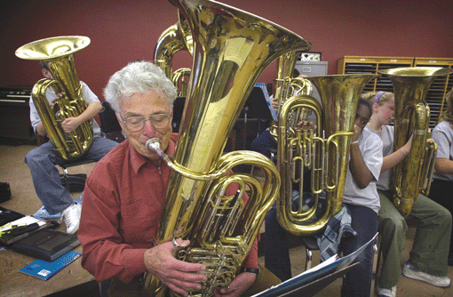 In 2002, Elliott Royce volunteered with a junior high school band, serving as both mentor and occasional tuba player.