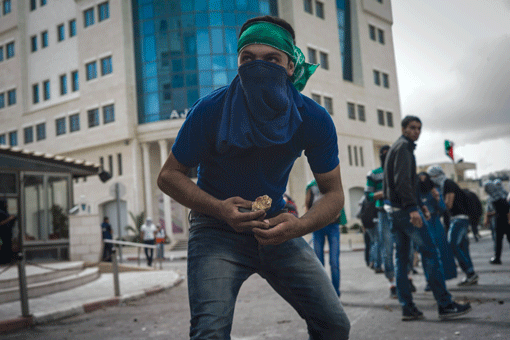 A Palestinian protester during clashes with Israeli security forces in the West Bank on Oct. 8. (Photo: Ilia Yefimovich / Getty Images)