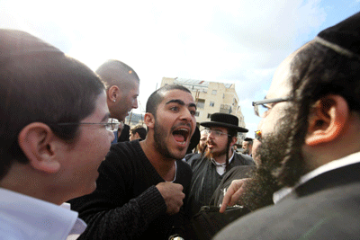 Haredi Orthodox men argue with secular Israelis in Beit Shemesh following demands that authorities crack down on religious extremists who want stricter gender segregation in the city on Dec. 26. (Photo: Kobi Gideon / Flash90 / JTA)