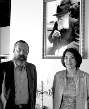Rabbi Gershon Giter and Yana Glikin stand beneath a portrait of the Lubavitcher Rebbe, the late Rabbi Menachem Mendel Schneerson, at CORE Center’s new location in Maple Grove. (Photo: Erin Elliott Bryan)