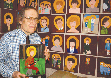 Herbert Savel, standing in front of a selection from his 1,200 artworks, holds a carving depicting Eliezer Zilber, a Jewish partisan fighter from Lithuania. (Photos: Courtesy of Dr. Herbert Savel)