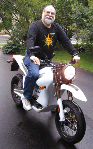 Krause-electric motorcycle Mike Krause recently purchased a Zero DS electric motorcycle, which can travel 15 miles per charge at highway speeds. (Photo: Erin Elliott Bryan)