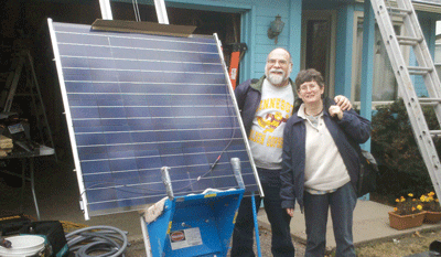 Mike and Marguerite Krause pose next to one of the 15 solar panels that were installed on their St. Louis Park home last fall. (Photo: Courtesy of Powerfully Green)