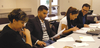 Four Education to Employment fellows, including Arie Bornstein (far right), work on their business plans during a recent workshop at Hamline University in St. Paul. (Photo: Erin Elliott Bryan)