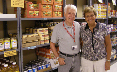 Food shelf volunteer Stu Yellen is pictured with executive director Jackie Olafson in STEP’s new building on Lake Street in St. Louis Park. (Photo: Erin Elliott Bryan)