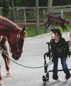 Pearl Pergament, who has cerebral palsy, connects with a horse at Hold Your Horses. (Photo: Courtesy of Heidi Pergament)