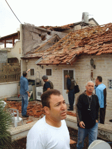 Avi Maman (center), a firefighter, returned home to Sderot, Israel, from his shift on Tuesday, shortly after a Kassam rocket hit his house. No one was injured in the attack. (Photo: Jewish Agency for Israel)