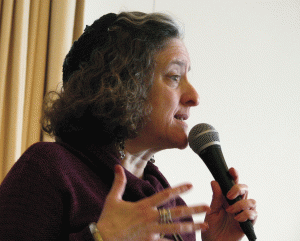 Rabbi Amy Eilberg (above) led Sunday’s Immigrant Rights Freedom Seder at Mount Zion, along with Rabbi Adam Stock Spilker. The Haggada, which Eilberg read from at times, notes that the Exodus story is shared by all people who are “struggling to hold on to who they are while emigrating to make a better life. Tonight, as we share this liberation story of the past we will hear from community members here with us this evening who are involved in a liberation struggle of today, that of immigrants in the United States.” The liturgy also acknowledges and honors the “First Nations people who lived here first, and have struggled against oppression to maintain their culture and way of life,” and African Americans who were “brought here against their will, many in chains,” and organized to gain their freedom. (Photo: Mordecai Specktor)